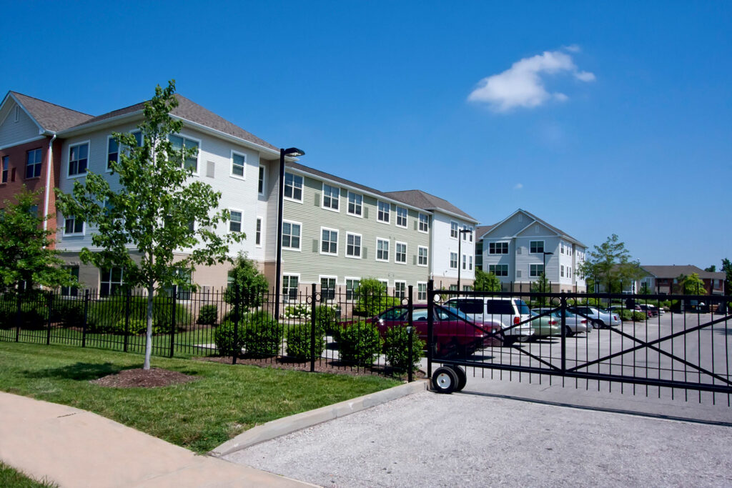 Cahill House building exterior gated parking lot.