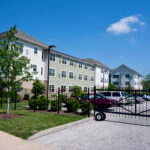 Cahill House building exterior gated parking lot.